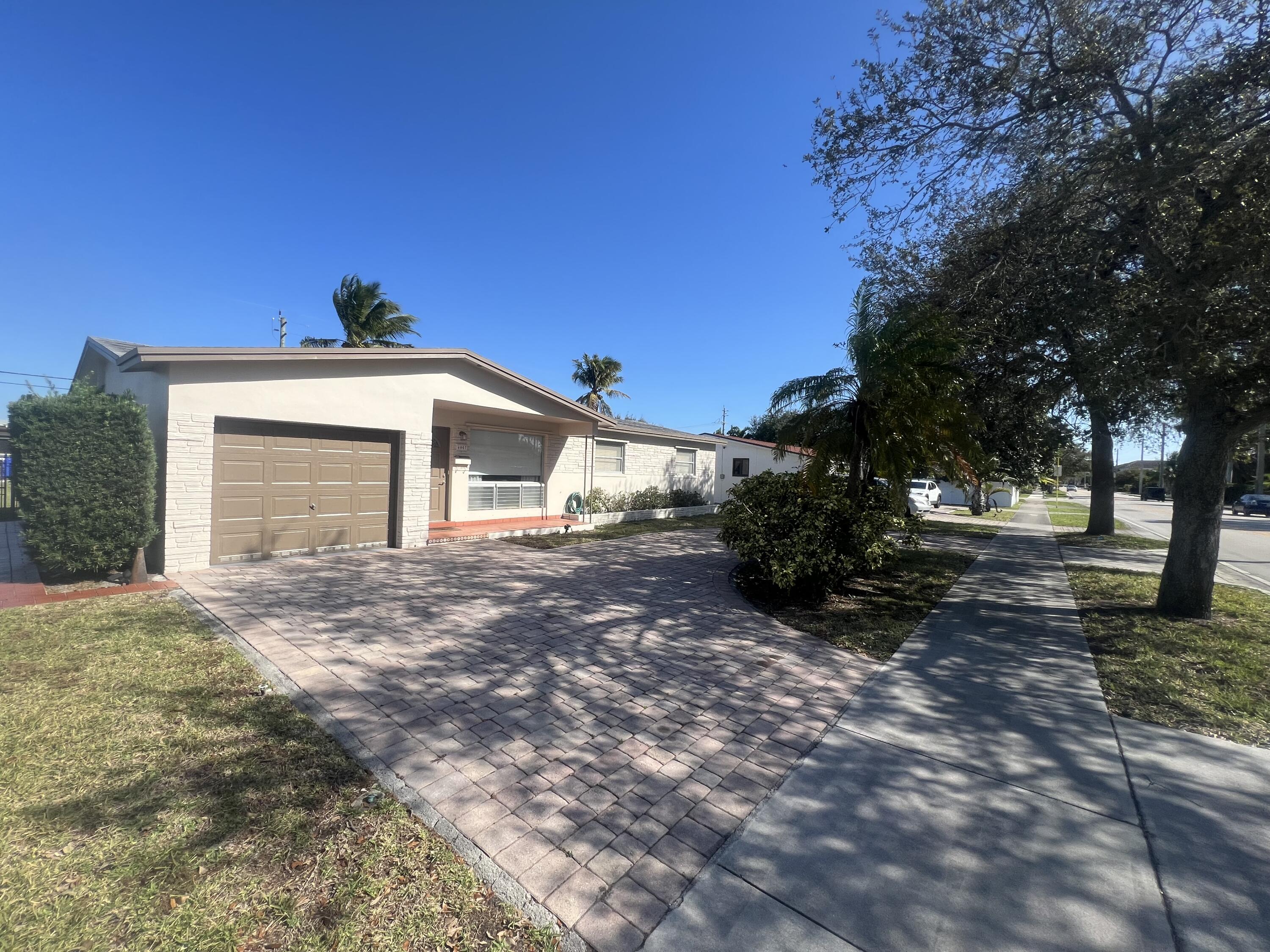4007 Johnson Street Hollywood, FL 33021 - Photo 2 of 14 a view of a house with a yard