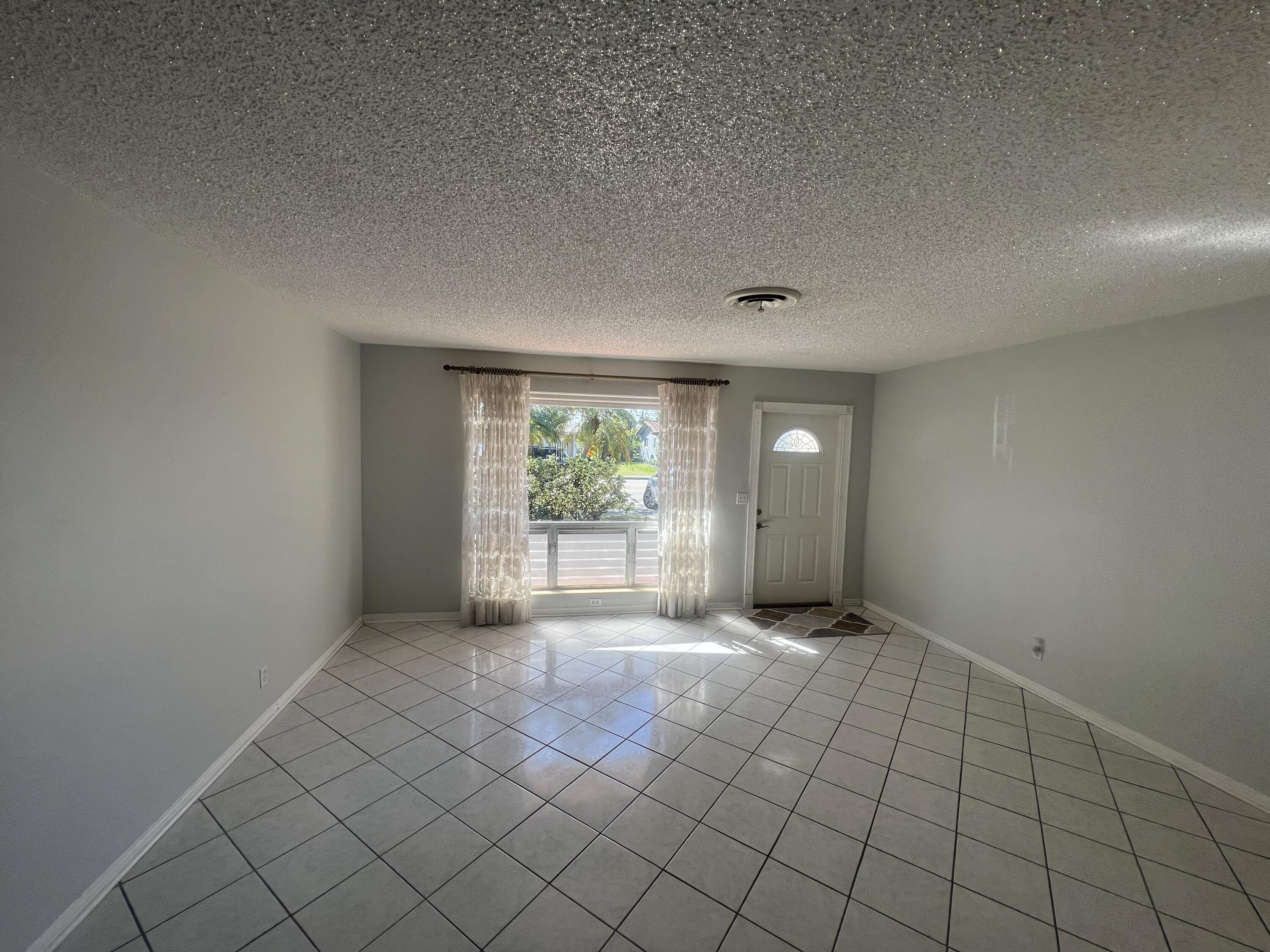 4007 Johnson Street Hollywood, FL 33021 - Photo 3 of 14 a view of an empty room and window