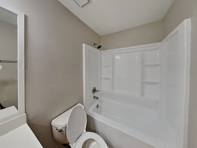 a bathroom with a toilet and a bathtub