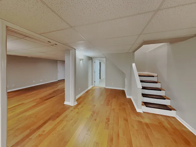 a view of a room with wooden floor and stairs