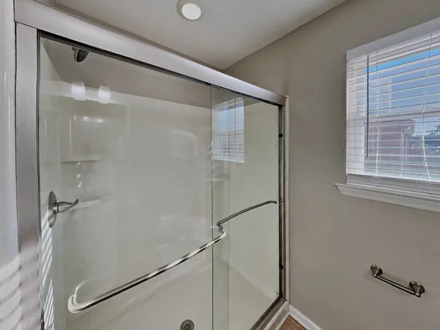 a bathroom with a glass shower door