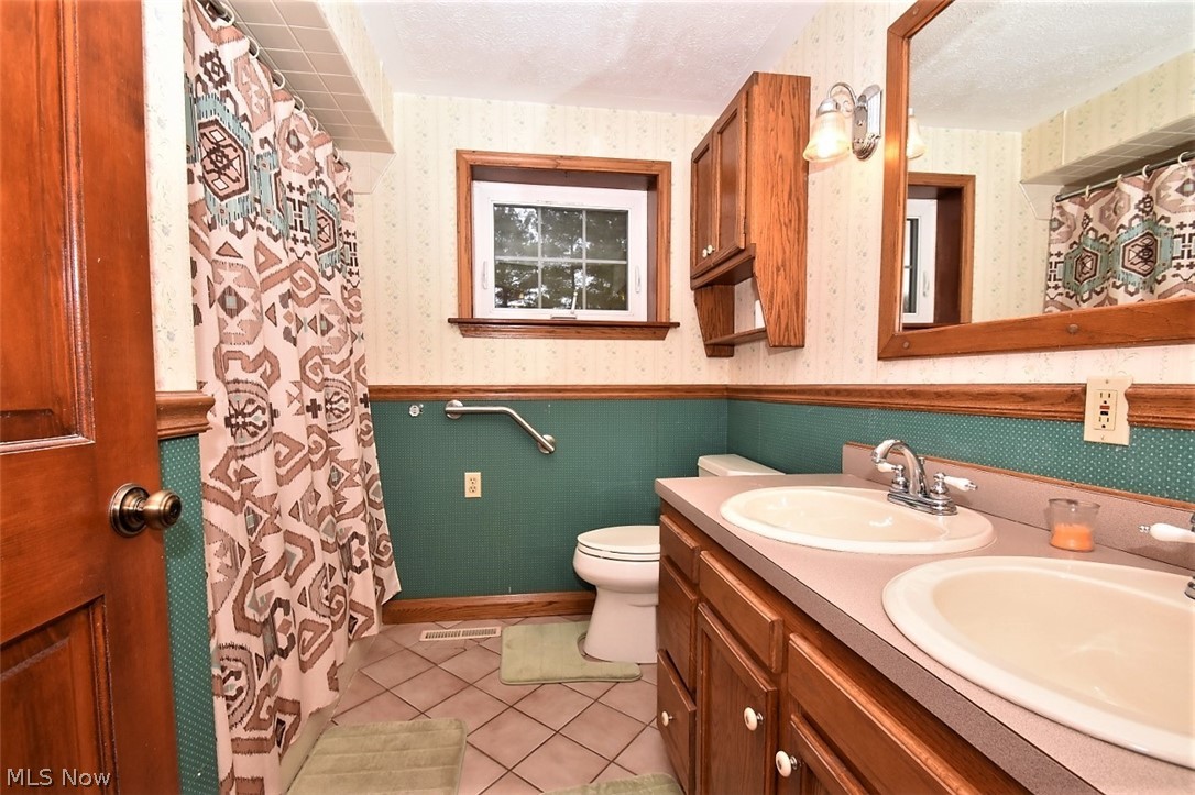 5652 Winchell Road Hiram, OH 44234 - Photo 14 of 25 Bathroom has two sinks and shower/tub combination. Stackable washer and dryer located here.
