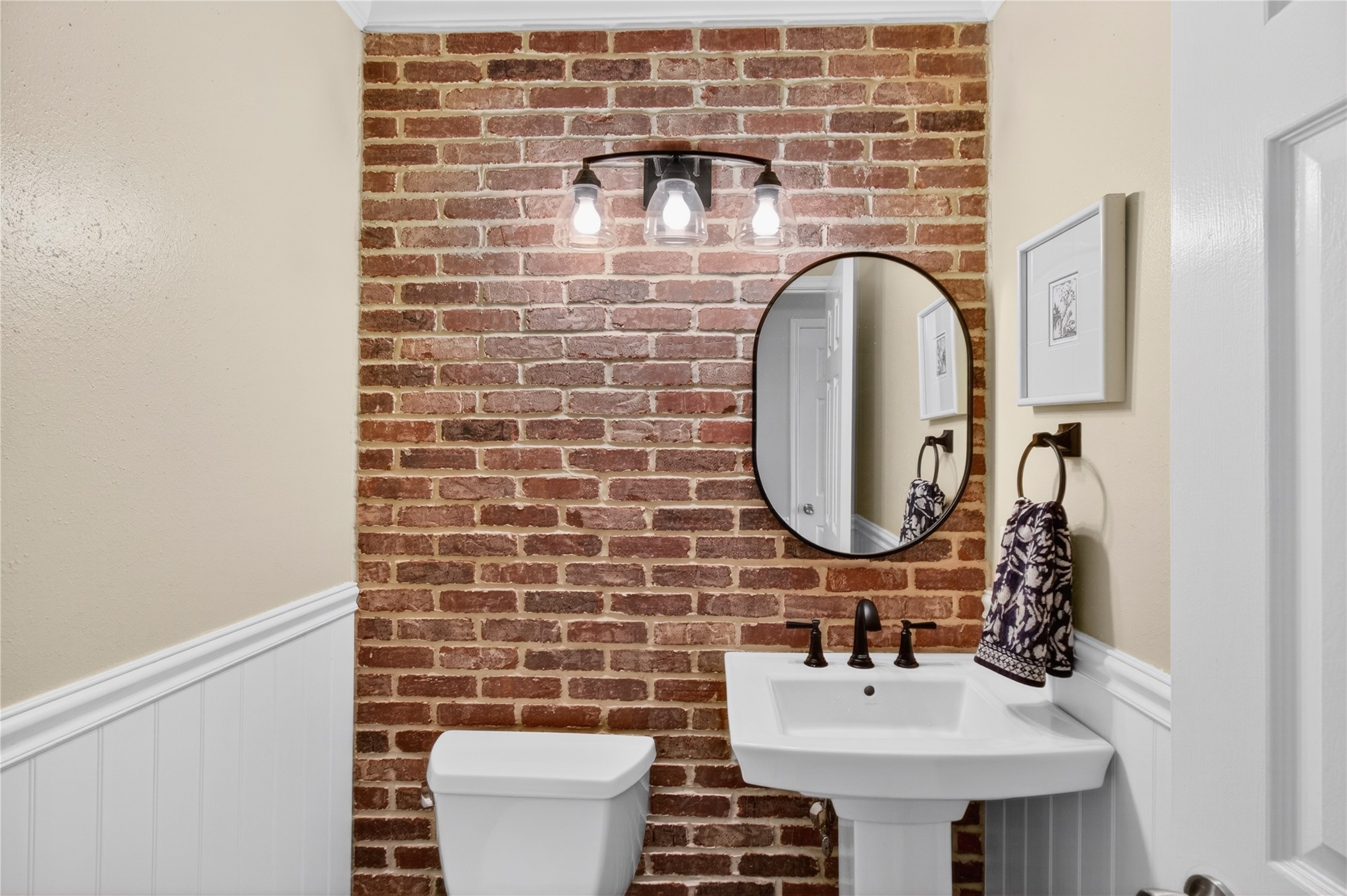20214 Woodsboro Court Spring, TX 77388 - Photo 25 of 50 Powder Half Bath! Recenlty Updated w/Brick Accent Wall, Lighting, Hardware, Pedestal Sink & Potty! Recently Painted Interior! Luxury Vinyl Plank throughout 1st Floor!