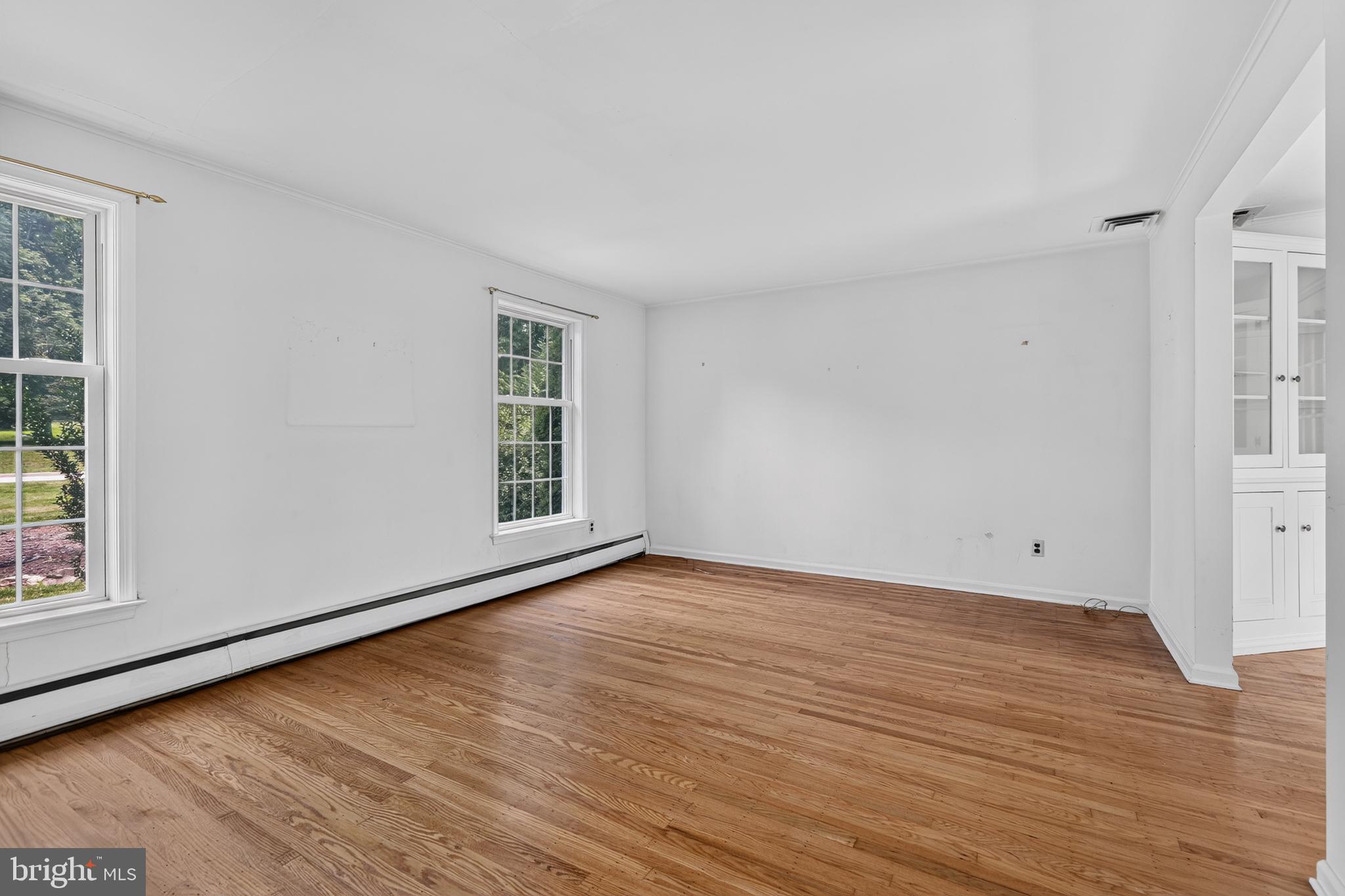 1408 Ponds Edge Road West Chester, PA 19382 - Photo 16 of 53 a view of an empty room with wooden floor and a window