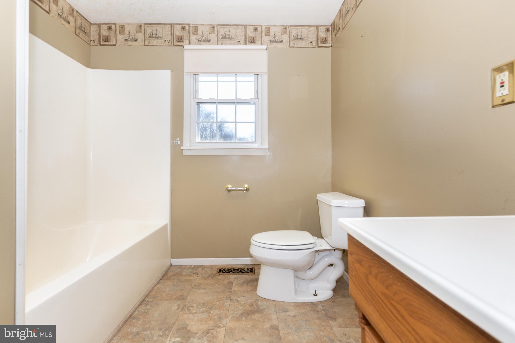 5 Sunset Drive Gettysburg, PA 17325 - Photo 14 of 56 a bathroom with a toilet a sink and a window