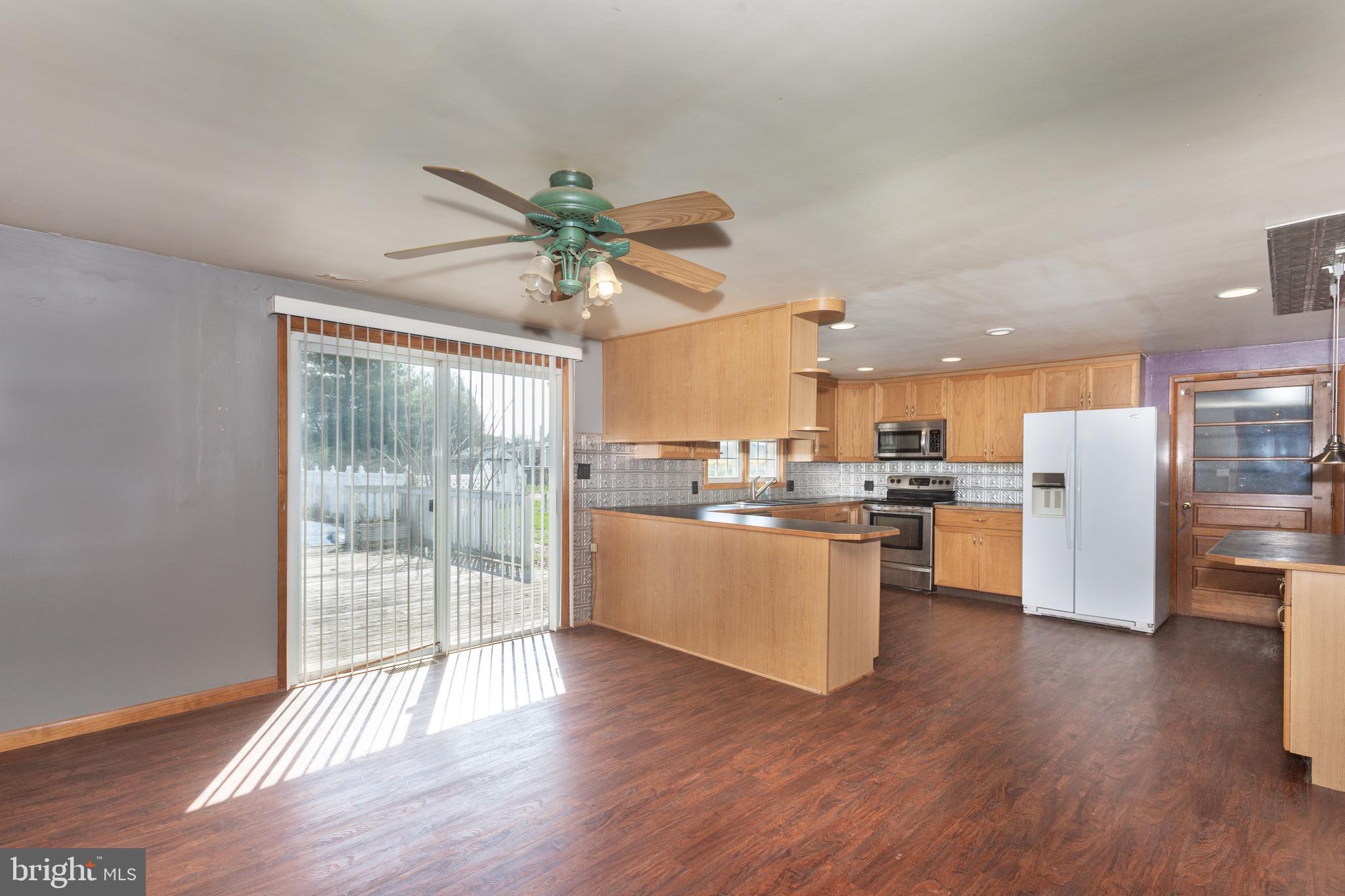 5 Sunset Drive Gettysburg, PA 17325 - Photo 41 of 56 a open kitchen with stainless steel appliances granite countertop a refrigerator a sink a stove and white cabinets with wooden floor