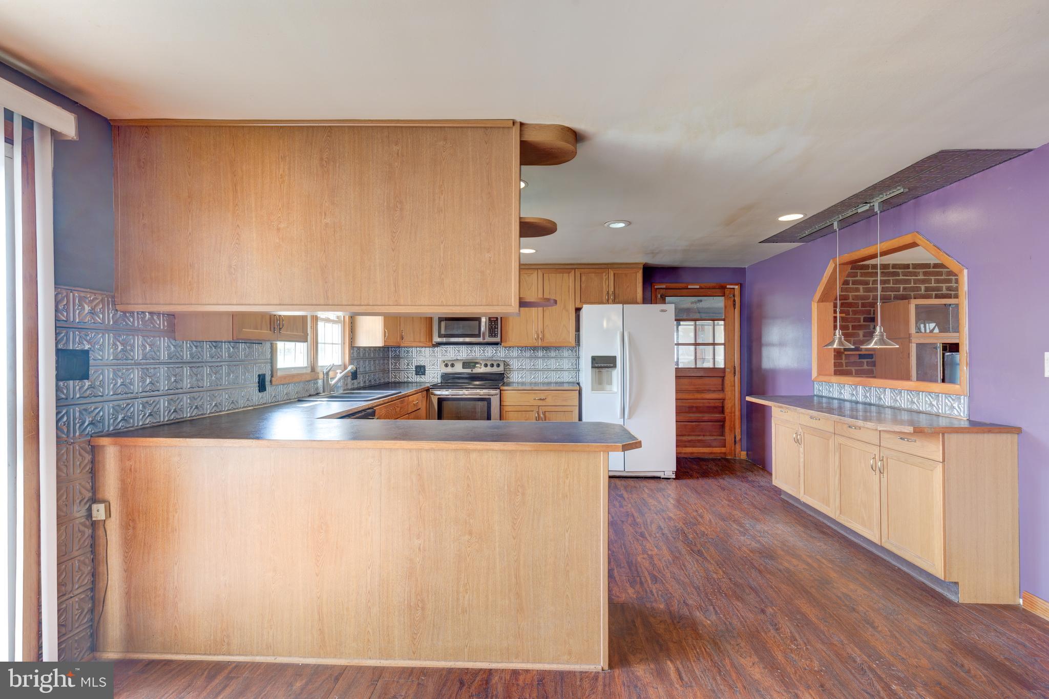 5 Sunset Drive Gettysburg, PA 17325 - Photo 42 of 56 a kitchen with stainless steel appliances granite countertop a refrigerator a stove and a wooden floors