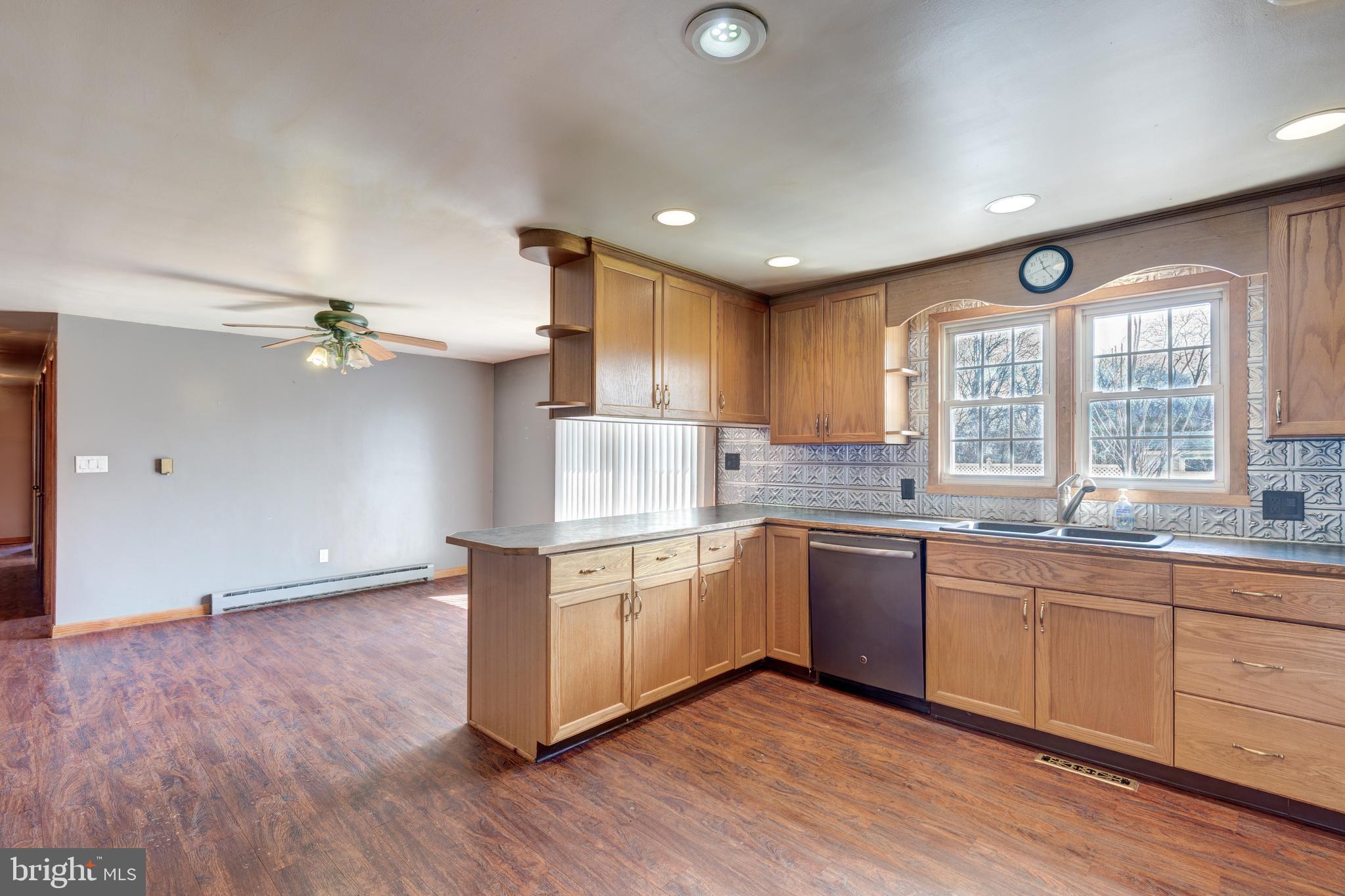 5 Sunset Drive Gettysburg, PA 17325 - Photo 5 of 56 a kitchen with stainless steel appliances granite countertop hardwood floor sink stove and wooden cabinets