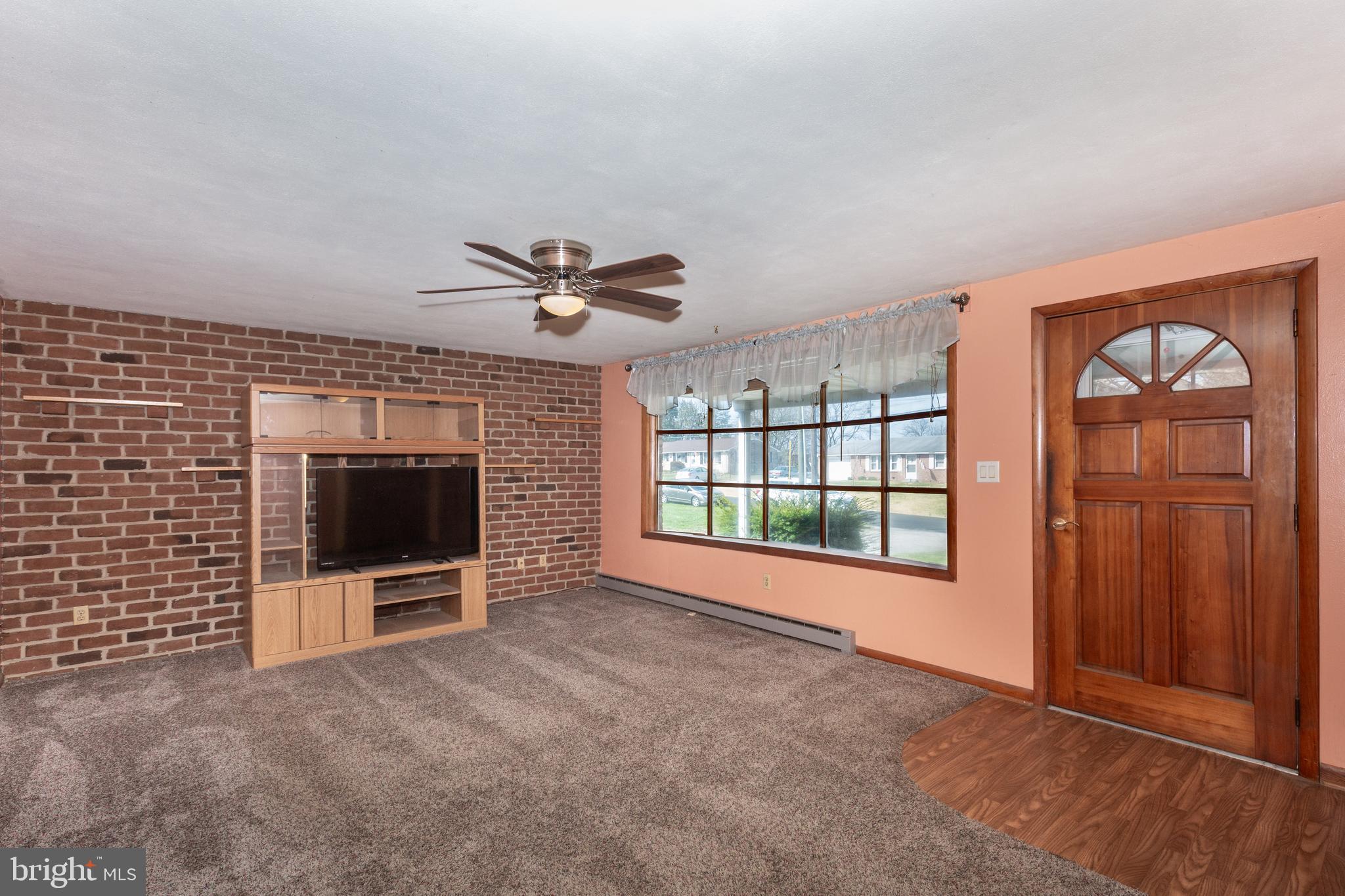 5 Sunset Drive Gettysburg, PA 17325 - Photo 7 of 56 a view of an empty room with a fireplace and a window