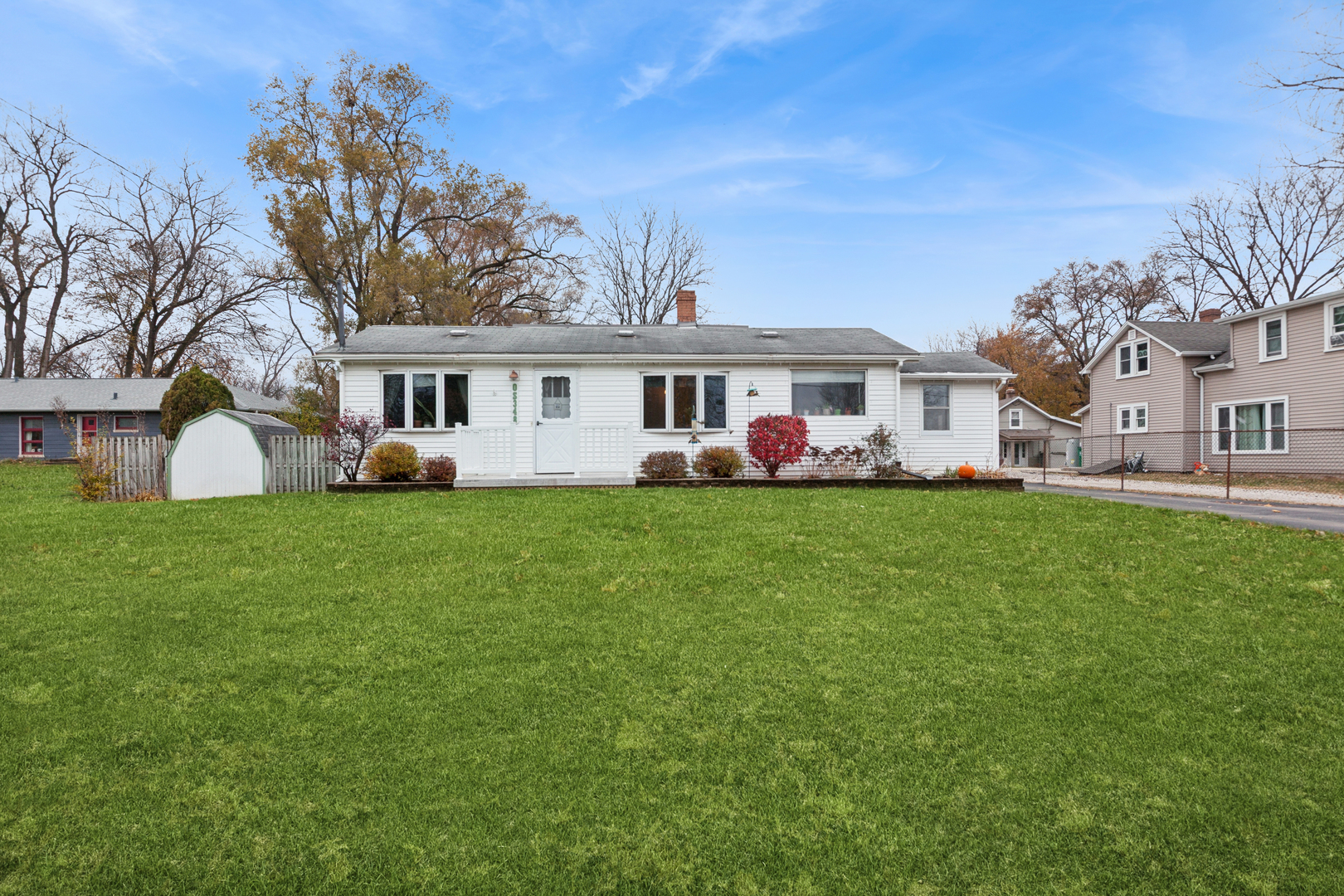 a front view of house with yard and green space