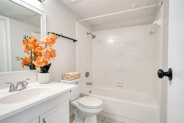 a bathroom with a sink mirror vanity and toilet