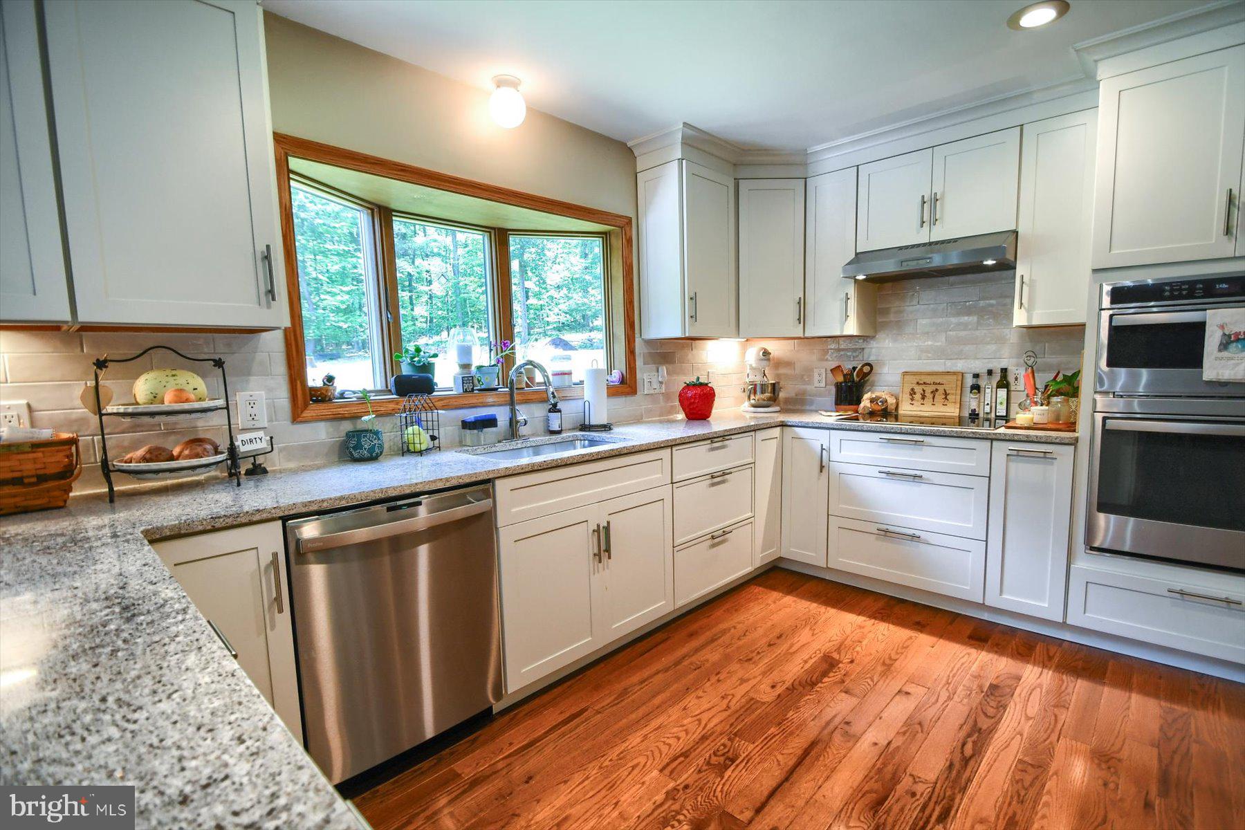 3700 Lehnenberg Road Riegelsville, PA 18077 - Photo 41 of 48 a kitchen with stainless steel appliances granite countertop a stove a sink and white cabinets