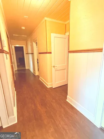 a view of a storage & utility room with refrigerator and a window