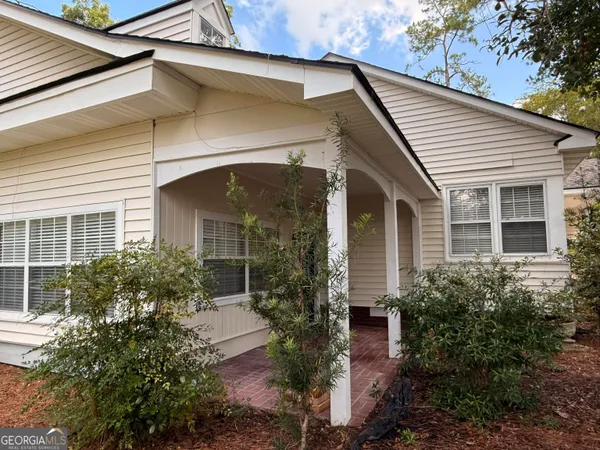 a front view of a house with garden