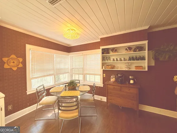 a living room with furniture and large windows