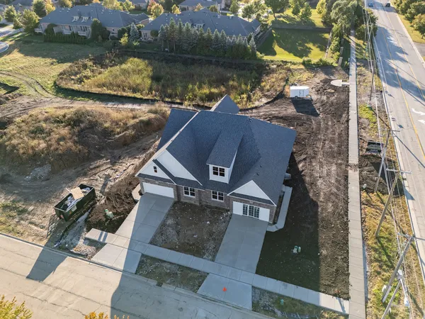 an aerial view of a house with a yard