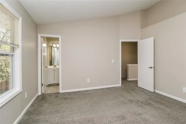 an empty room with windows and closet