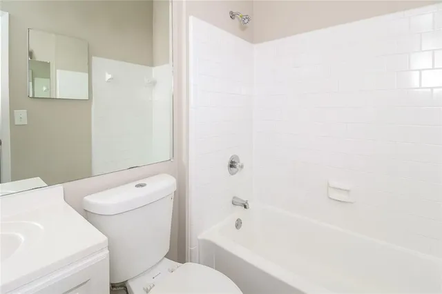 a bathroom with a sink a toilet and bathtub