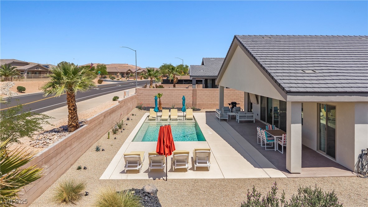 1357 Manassas Ridge Mesquite, NV 89027 - Photo 63 of 72 View of pool with a patio, a fenced backyard, and an outdoor living space