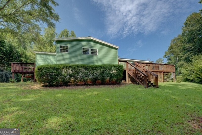 119 Shoals Point Eatonton, GA 31024 - Photo 107 of 110 a front view of a house with a yard