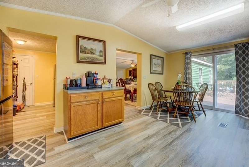 119 Shoals Point Eatonton, GA 31024 - Photo 24 of 110 a view of a dining room with furniture and wooden floor