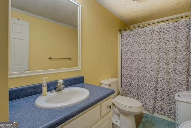 a white toilet sitting next to a shower curtain