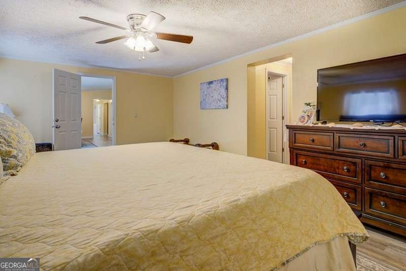 119 Shoals Point Eatonton, GA 31024 - Photo 36 of 110 a bedroom with a bed and a flat screen tv