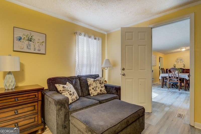 119 Shoals Point Eatonton, GA 31024 - Photo 38 of 110 a living room with furniture and a wooden floor