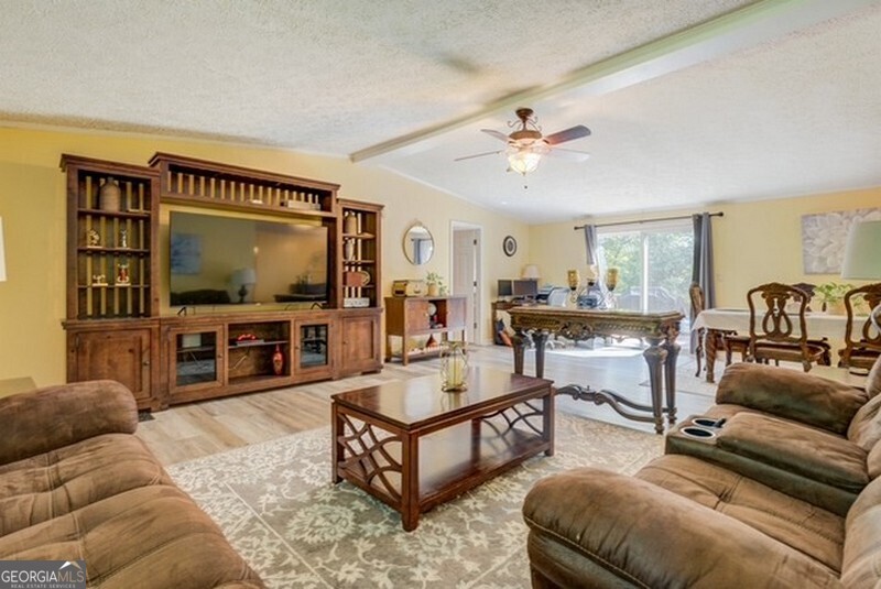 119 Shoals Point Eatonton, GA 31024 - Photo 45 of 110 a living room with furniture and a flat screen tv