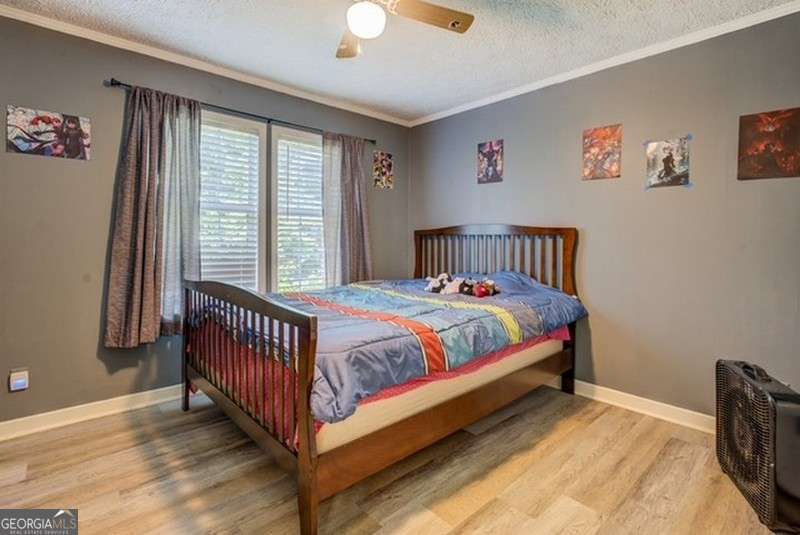 119 Shoals Point Eatonton, GA 31024 - Photo 50 of 110 a bed sitting in a bedroom next to a window