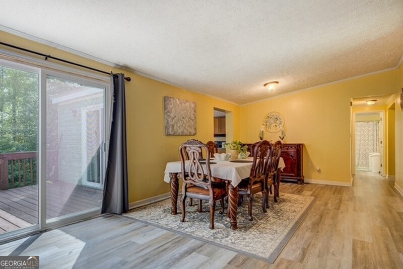 119 Shoals Point Eatonton, GA 31024 - Photo 51 of 110 a view of a dining room with furniture and wooden floor
