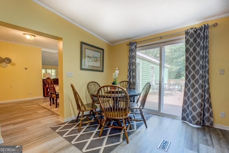 119 Shoals Point Eatonton, GA 31024 - Photo 57 of 110 a view of a dining room with furniture and wooden floor