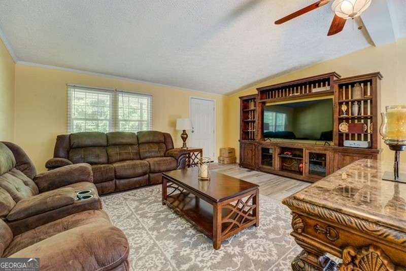 119 Shoals Point Eatonton, GA 31024 - Photo 6 of 110 a living room with furniture and a flat screen tv