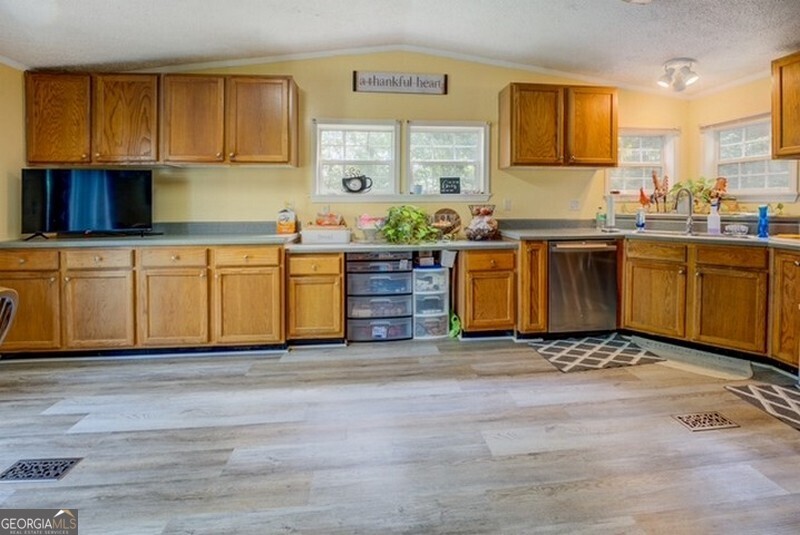 119 Shoals Point Eatonton, GA 31024 - Photo 61 of 110 a kitchen with stainless steel appliances granite countertop a stove a sink and a refrigerator