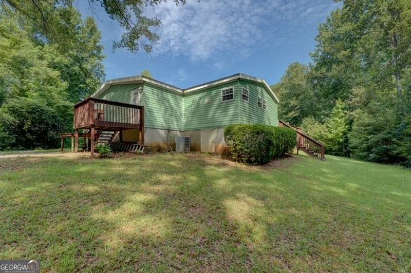 119 Shoals Point Eatonton, GA 31024 - Photo 68 of 110 a backyard of a house with outdoor seating and green space