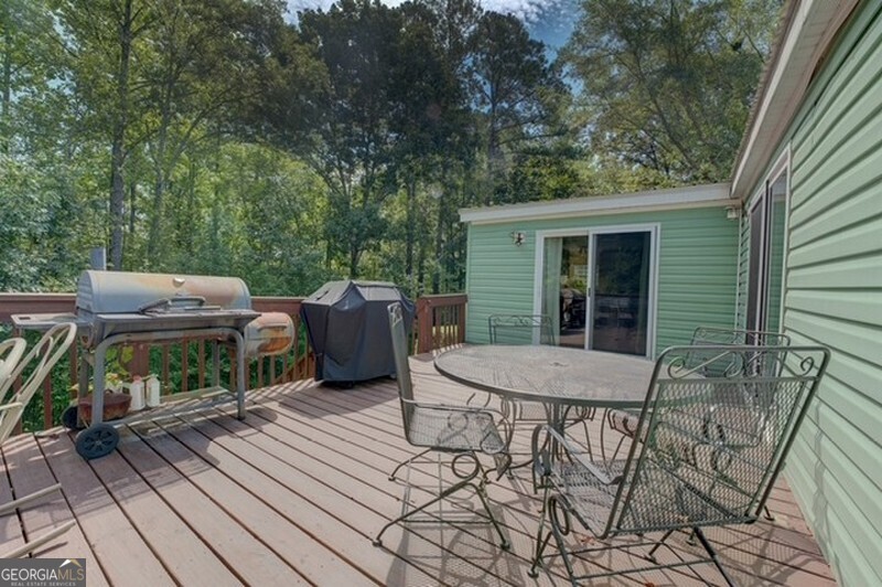 119 Shoals Point Eatonton, GA 31024 - Photo 7 of 110 a view of a patio with table and chairs with wooden floor and fence