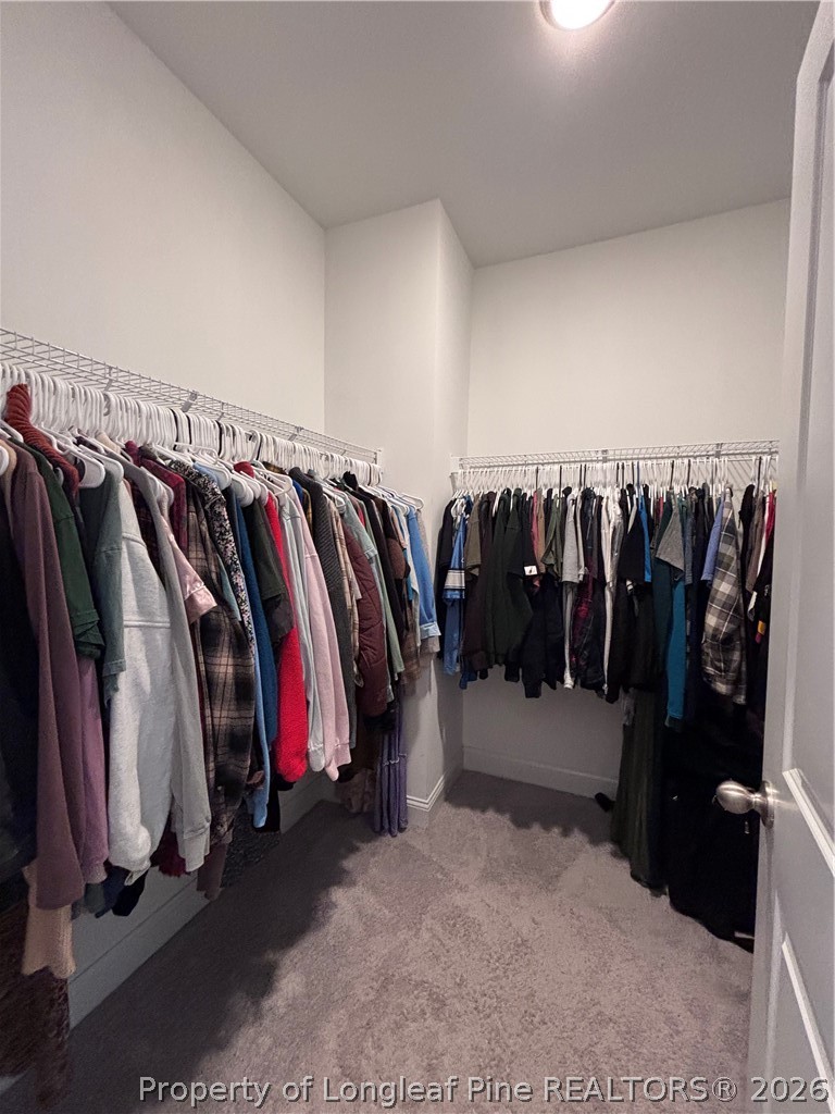 7720 Rufus Johnson Road Fayetteville, NC 28306 - Photo 42 of 50 a view of walk in closet with clothes