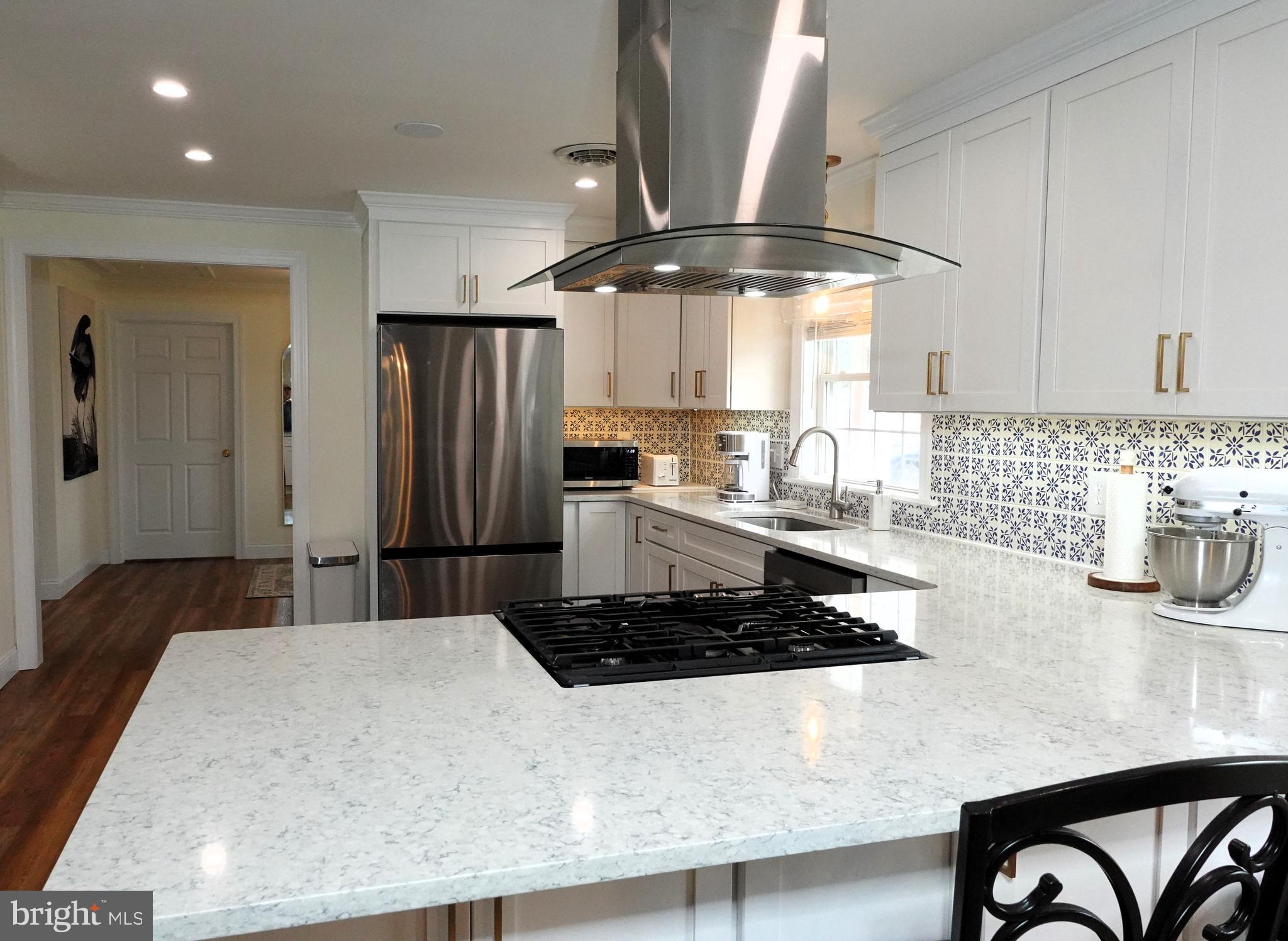 1604 Deep Point Road Woolford, MD 21677 - Photo 8 of 49 a kitchen with stainless steel appliances granite countertop a sink a stove and a refrigerator
