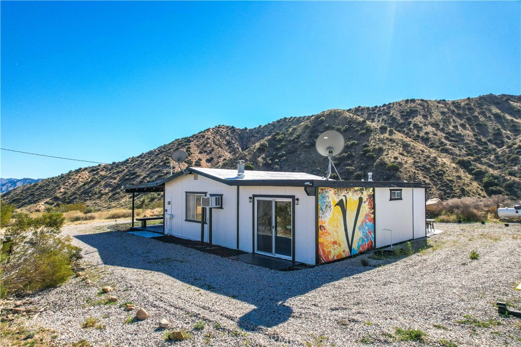 49490 Big Morongo Canyon Road Morongo Valley, CA 92256 - Photo 46 of 75 a view of a house with a mountain in the background