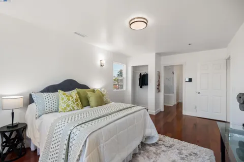 a bathroom with a granite countertop tub sink and mirror