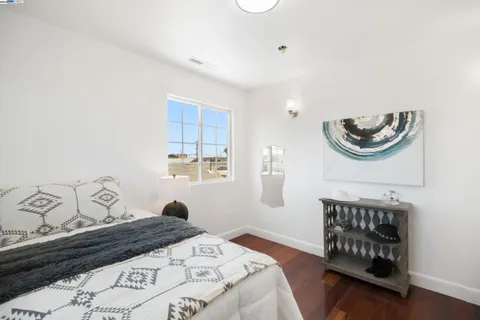 a living room with furniture and a view of kitchen
