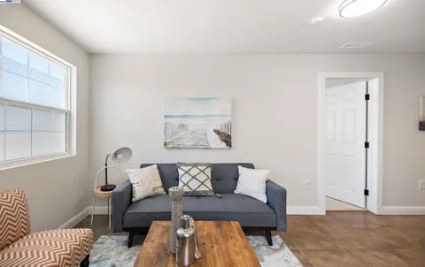 a living room with furniture and a rug