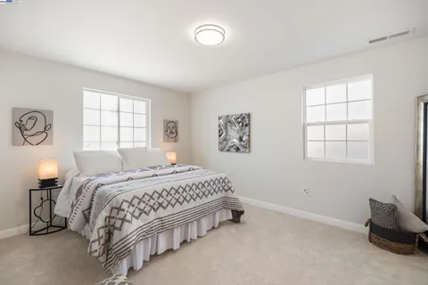 a bedroom with a bed and a couch