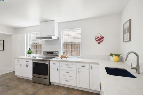 a kitchen with sink and cabinets