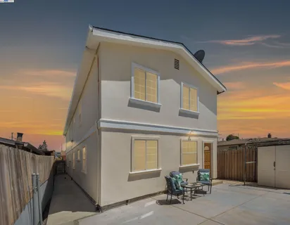 a front view of a house with plants