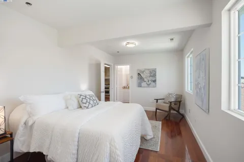 a bathroom with a granite countertop sink mirror vanity bathtub and a toilet