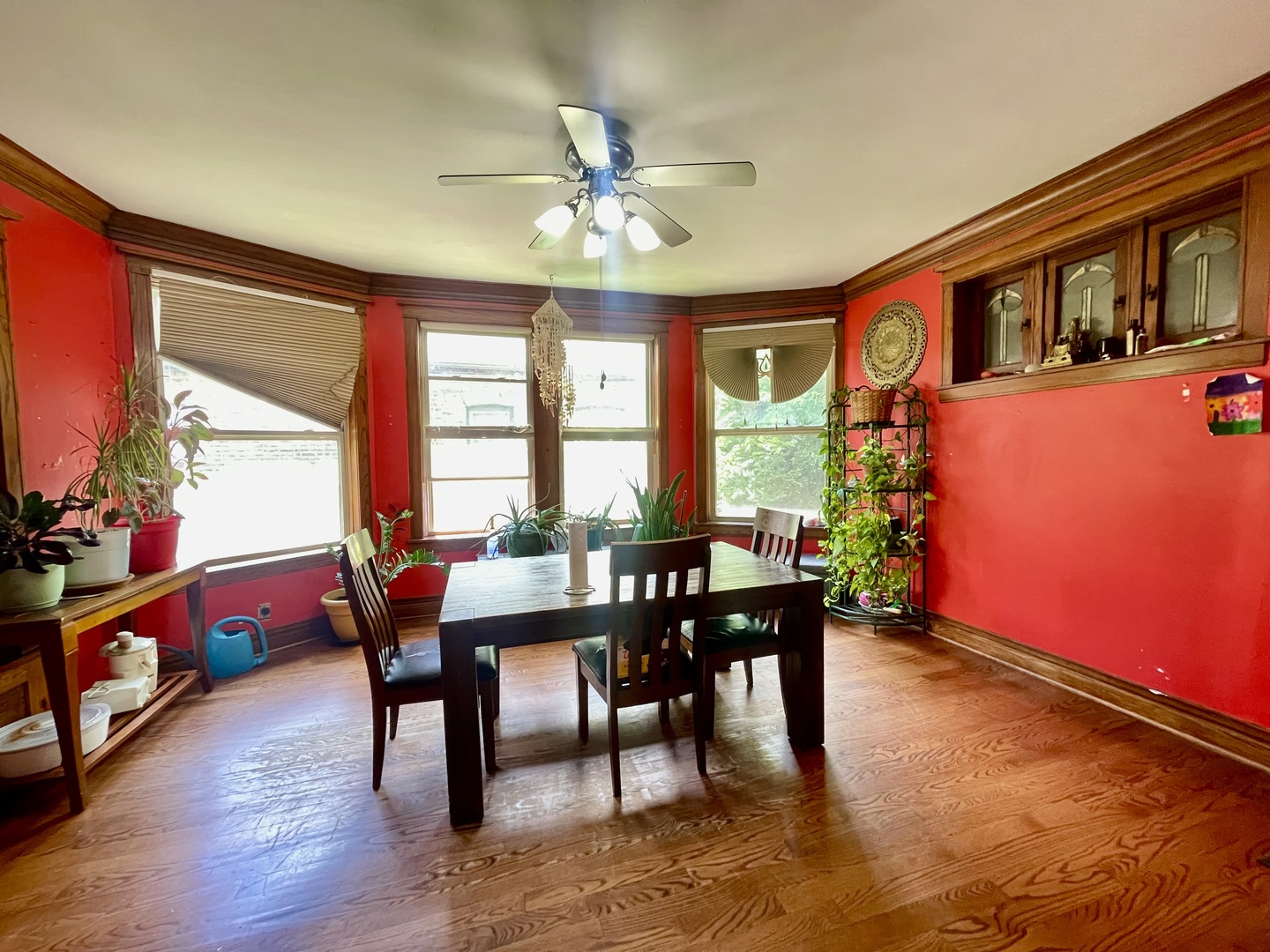 7916 South Constance Avenue Chicago, IL 60617 - Photo 9 of 28 a dining room with furniture a chandelier and wooden floor