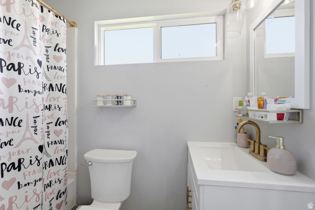 2500 North Fort Lane, Unit 220 Layton, UT 84041 - Photo 19 of 23 Bathroom featuring a single vanity with a white countertop and integrated sink, a two-piece toilet, and a white framed mirror