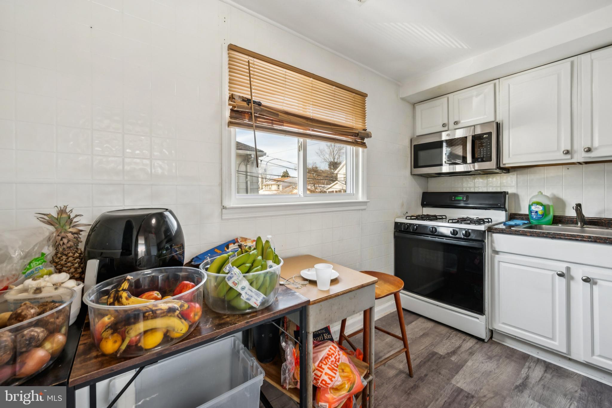 640 Bem Street Riverside, NJ 08075 - Photo 20 of 26 a kitchen with stainless steel appliances kitchen island granite countertop a stove a sink and a microwave