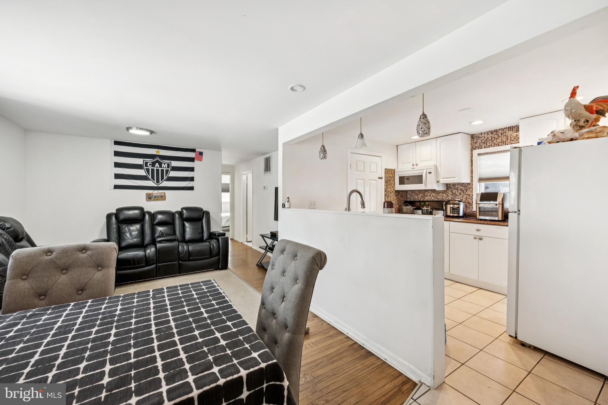 640 Bem Street Riverside, NJ 08075 - Photo 5 of 26 a kitchen with stainless steel appliances kitchen island granite countertop a refrigerator a stove a sink dishwasher and white cabinets with wooden floor